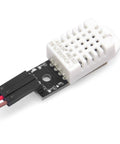 Close-up of DHT22 AM2302 Digital Humidity and Temperature Sensor Module for Arduino and Raspberry Pi with wiring connectors visible.