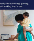 Woman holding baby, working on laptop, demonstrating Like-New Eero 6 Mesh WiFi Extender for Up to 1,500 Sq Ft Boost, Add-On Coverage