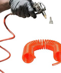 Heavy Duty PU Air Compressor Hose With Spiral Winding For Gas Pumps And Air Tools Badass Flex Handles High Pressure Everyday Use Slick Black Finish No Fuss Pneumatic Tubing Guaranteed To Perform held with tool and orange tubing.