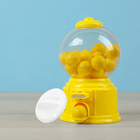 Upgrade Your Arcade Vibes With This Round Plastic Replacement Knob For Vending Machines And Party Games. A yellow gumball machine with round yellow balls.