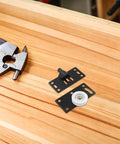 8 Pairs Black Carbon Steel Sliding Door Wheels For Closets And Wardrobes Rock Solid Heavy Duty Cabinet Pulleys Built Damn Tough With Smooth Gliding Performance Runs Like A Dream Daily, featuring black steel roller wheels on wooden surface.