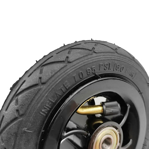 Five Inch Pneumatic Tire With Inner Tube And Heavy Duty Steel Hub Featuring 5X1 Bolt Pattern For Go Kart and Caster Wheels close up of tread and valve.