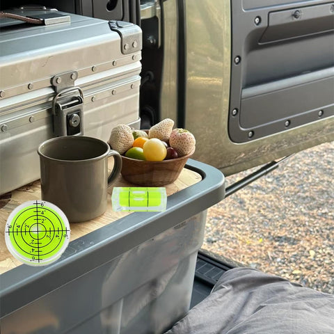 Mini Acrylic Bubble Spirit Level Pack With Hella Precise Degree Markings for outdoor table leveling beside fruit bowl.