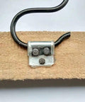 Heavy Duty Upholstery Spring Clips For Sofas And Couches No Hassle Furniture Repair Kit attached to wood with zigzag spring hooks.