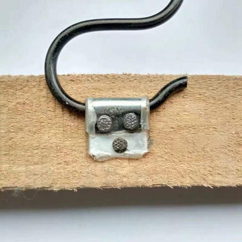 Heavy Duty Upholstery Spring Clips For Sofas And Couches No Hassle Furniture Repair Kit attached to wood with zigzag spring hooks.