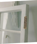 Side view of white wooden cabinet door with brass piano hinge along edge.