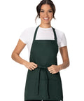 Unisex Three Pocket Hunter Green Apron With Adjustable Neck Strap And Waist Ties worn by model, front view, suitable for servers and cooks.