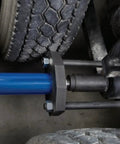 Heavy Duty Workhorse 15 Ton Air Hydraulic Rear Suspension Bushing Removal Tool Kit with adapter set in use on a truck.