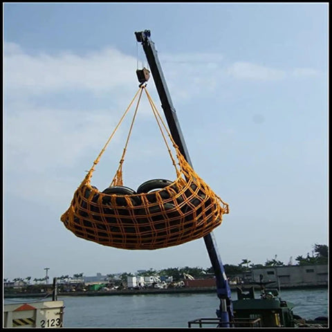 Rugged Heavy Duty Hanging Cargo Net For Lifting And Securing Freight Built To Haul with reinforced edges, elevated high by crane
