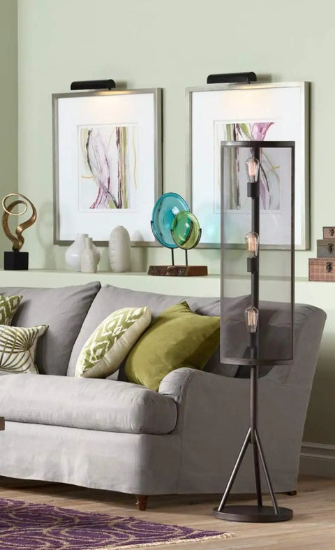 Battery Operated Picture Light With Wireless Remote Control Dimmable Art Light For Wall Or Frame Tilts To Direct Light 7.75 Inch Metal Black Picture Lamp illuminating artwork above sofa in living room.