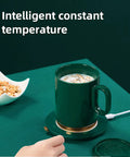 Smart Thermostatic Usb Coffee Mug Warmer Set To Keep Your Daily Brew Hot And Smooth Without Any Cold Cup Vibes Electric Heater Coaster on a green surface with snacks.