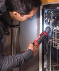 Person using Two Tool Cordless Drill And Right Angle Impact Kit with 12V Brushless Power on kitchen appliance