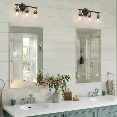Three Light Bathroom Vanity Light With Clear Globe Shade, Black And Brass Modern Wall Sconces Over Mirror in bathroom