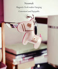 Heavy Duty Magnetic Hooks 30Lb Pack Of 4 For Fridge And Grill Hangers Extra Strong NdFeB Magnets holding a pink keychain