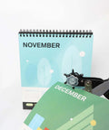 Multi Function Hole Punch Plier Set With Storage Case shown punching holes in a calendar page for paper crafts and DIY projects