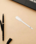 Fountain Pen Flusher Kit With Precise Nib Flush Pipette For Ink Removal And Cleaning next to black pens and laptop on table