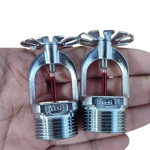 Quick Response Pendent Fire Sprinkler Head 155F Chrome Brass Half Inch Red Glass Bulb on a hand showing details.