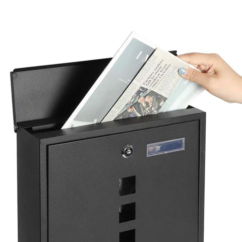 Person inserting newspaper into Stainless Steel Mailbox With Key Lock Wall Mounted Large Capacity Mailbox With Newspaper Compartment