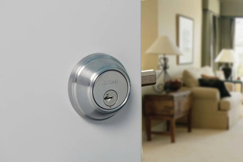 SmartKey Security Exterior Deadbolt With Keyed Entry In Satin Nickel Model 980 on white door with home interior view