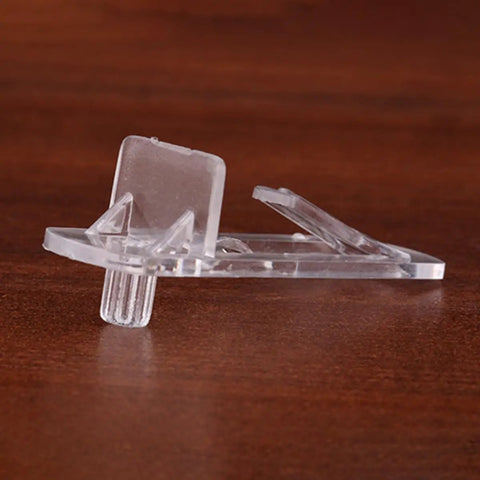 Close-up of a clear plastic shelf clip from the 30 Pack Plastic Cabinet Shelf Clips for 15mm to 16mm wooden boards, side view.
