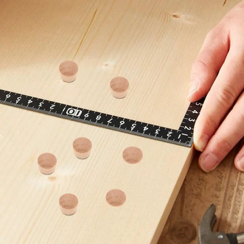 Pro Grade 50 Piece Wood Plug Set for Screw Holes and Carpenter Bee Repair on wooden board with measuring tape