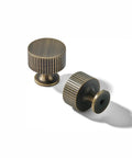 Rad 1 Inch Brushed Antique Brass Cabinet Knobs 5 Pack With Badass Grip And Fluted Design For Kitchen Cabinets And Bathrooms. Two knobs with fluted design.