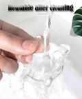 Hand washing a clear rubber bumper shield; demonstrates how the product is reusable after cleaning.