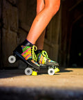 Person skating outdoors with colorful quad skates featuring 4 Piece PU Double Row Roller Skate Wheels With Bearings For Quad Skating.