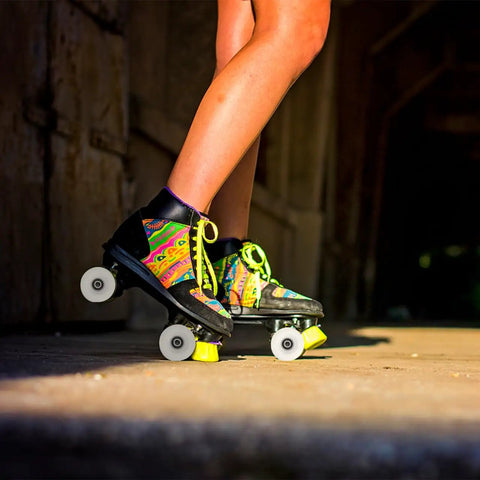 Person skating outdoors with colorful quad skates featuring 4 Piece PU Double Row Roller Skate Wheels With Bearings For Quad Skating.