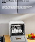 Plug And Play Portable Countertop Dishwasher Automatic Smart Wash System With Built In Storage and Disinfection Mode No Install Headaches Compact size with bowls and chopsticks in view.