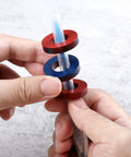 Hands holding ring magnets on a clear tube from Magnetism Science Kit for Kids and Teens Hands On Physics Experiments STEM Education Toy Set with Magnets Iron Filings Car Magnets Compass and More for Fun Learning.