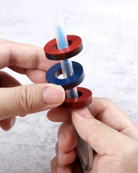 Hands holding ring magnets on a clear tube from Magnetism Science Kit for Kids and Teens Hands On Physics Experiments STEM Education Toy Set with Magnets Iron Filings Car Magnets Compass and More for Fun Learning.