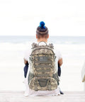 Person wearing Beefy 30L Tactical Backpack For Men With Molle System Waterproof Day Pack For Hiking And Outdoor EDC ACU Style Military Rucksack.