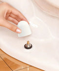 Universal Toilet Bolt Caps Pack of 6, White 1.44 Inch Round Push On Covers With Washers shown being installed on toilet bolt