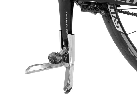 FlashStand Slim X Bike Stand for Road Bikes holding 700C wheel crankarm upright, silver and black design on flat surface