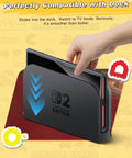 Nintendo Switch 2 being inserted into the dock, demonstrating compatibility and ease of use in TV mode.