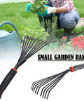 13 Inch Stainless Steel Handheld Shrub Rake With Nine Claws For Soil Loosening and Weeding in Small Gardens, shown with flowers