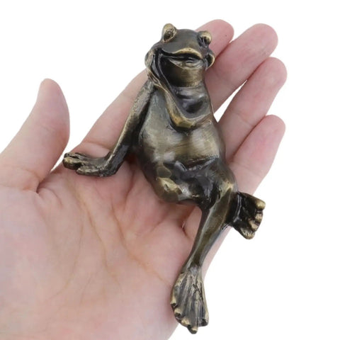 Hand holding a Frog Shaped Cabinet Knob Set, Solid Brass Antique Finish Drawer Pulls, 3.9 Inch Long By 1.4 Inch Wide, 2-Pack.