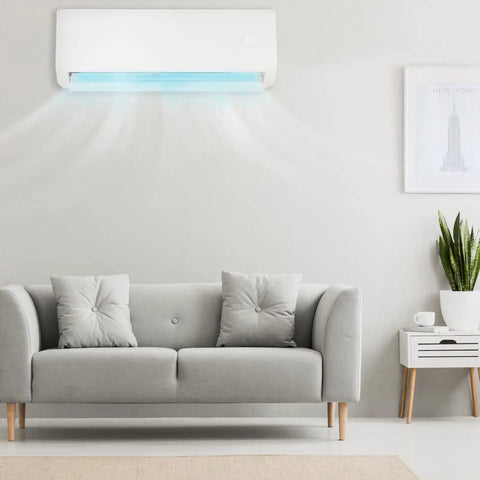 12000 BTU Mini Split Air Conditioner With Inverter 19 Seer Ductless Heat Pump installed above a light gray couch in a modern living room.