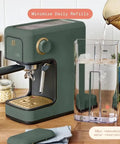 Rock Solid Compact Espresso Machine In Fresh Thyme Green with 50oz water reservoir and gold accents on kitchen countertop.