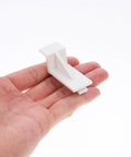 White Plastic Fridge Shelf Clips Set Of 10 For Freezers And Refrigerators shown in hand for size reference.