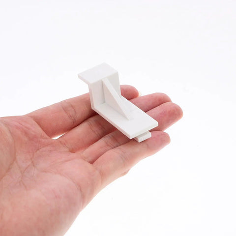 White Plastic Fridge Shelf Clips Set Of 10 For Freezers And Refrigerators shown in hand for size reference.