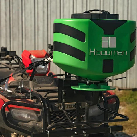ATV Seeder With 125 Lb Hopper And Universal Mounting System For Easy Fit shown on an ATV, ideal for land management.