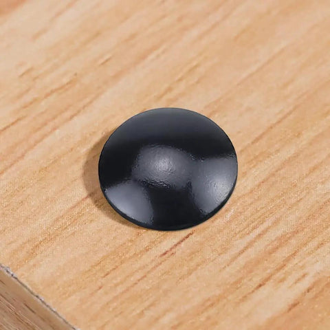 Black coated flat washer in detail on wood surface from 20 Piece Top Notch Carriage Bolt Kit With Hex Nuts And Flat Washers 5 16 by 1 1 2 304 Stainless Steel Black Coated Square Neck Fasteners For Kickass Projects And Weekend Warrior Builds.