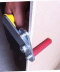 Close-up of adjustable drywall hoist grip with yellow handle, used for plasterboard and glass panels, job site essential.