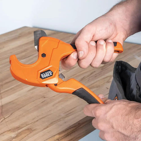 Ratcheting PVC Pipe Cutter For One Handed Use That Cuts One And A Quarter Inch ID PVC CPVC And PEX Lightweight With Soft Gripped Handles And Replaceable Blades For Fast Clean DIY Friendly Pro Level Pipe Work shown in use