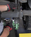 Mechanic using 36V MultiVolt Half Inch Mid Torque Cordless Impact Wrench Workhorse Tool with LED Light under a vehicle