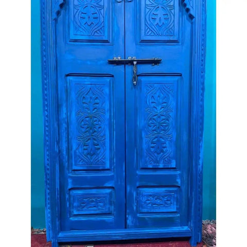 Blue Finish Hand Carved Barn Door With Custom Size Options, Double Or Single Panel, Sliding Or Hinged, Suitable For Interior Or Exterior Use, Front Door Style With Antique And Modern Flair, Made To Order with intricate carvings and vibrant blue color in focus.