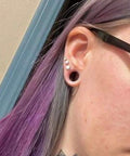 Side view of ear with 10G Clear Silicone Ear Gauges Tunnels Plugs Retainer Set Four Pairs Ultra Thin Soft Flexible Double Flared Saddle Jewelry