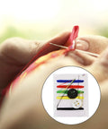 Close-up of hands using On The Go Travel Sewing Kit For Quick Fixes With Needles Threads Buttons And Safety Pin Emergency Repair Set